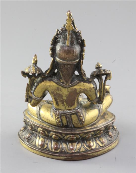 A Tibetan gilt copper alloy seated figure of Green Tara, 17th / 18th century, height 16.5cm